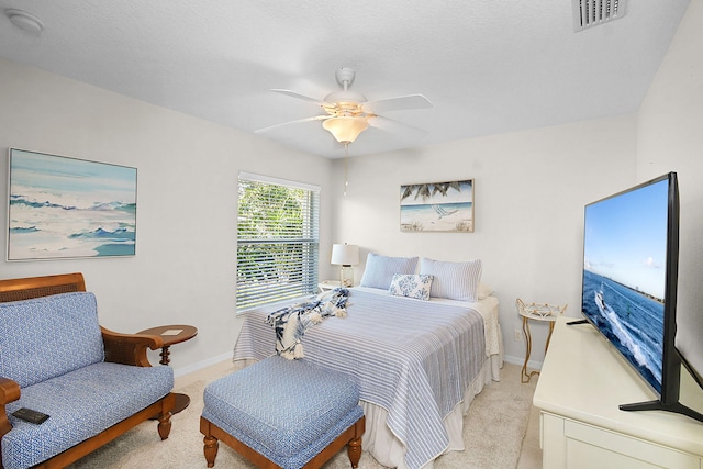 bedroom with light colored carpet and ceiling fan