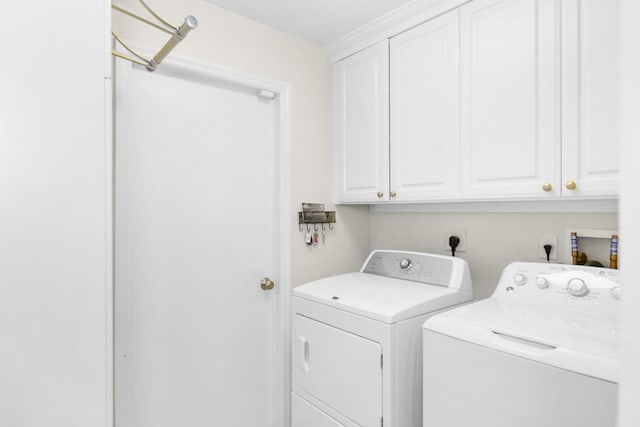 laundry room with cabinets and washing machine and clothes dryer