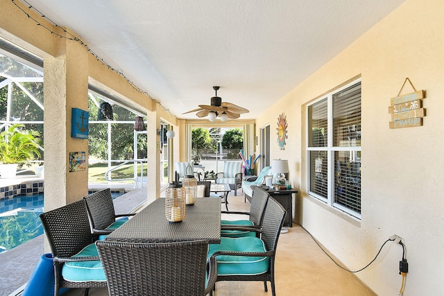 sunroom featuring ceiling fan