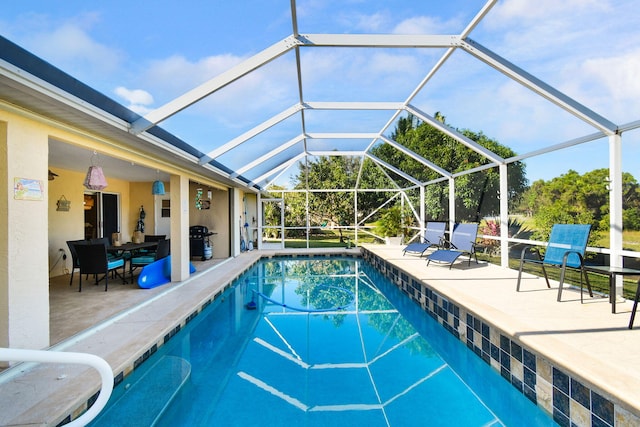 view of swimming pool with a patio and a lanai