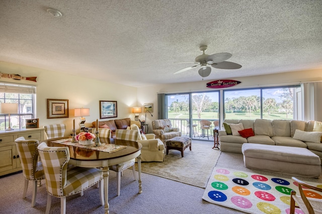 living room with a textured ceiling, ceiling fan, a healthy amount of sunlight, and light carpet