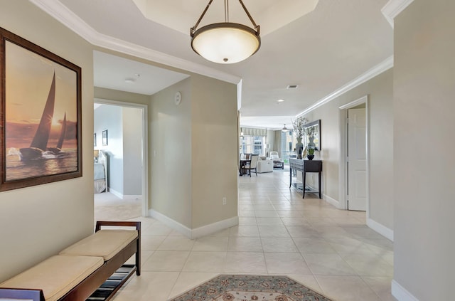 corridor featuring crown molding and light tile patterned floors