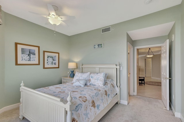 bedroom featuring light colored carpet and ceiling fan