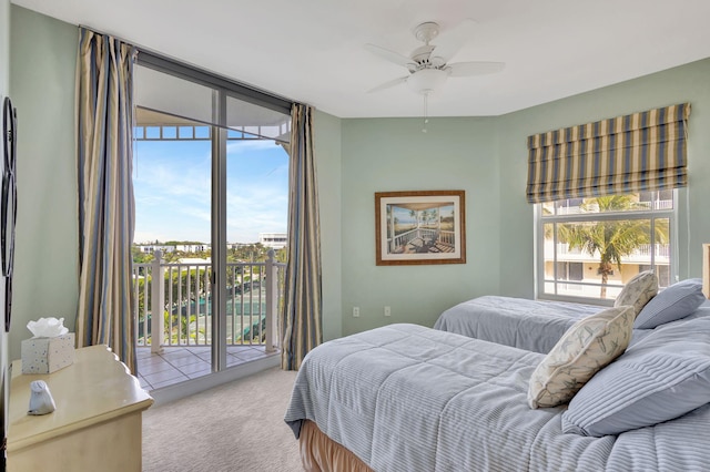 bedroom with access to outside, floor to ceiling windows, ceiling fan, and carpet flooring