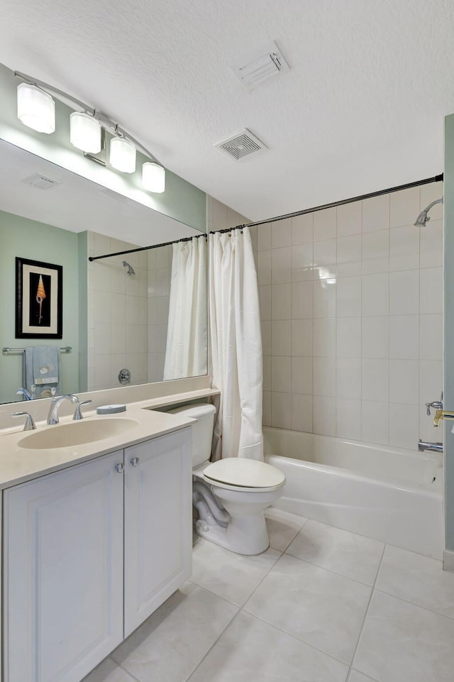 full bathroom featuring vanity, tile patterned flooring, toilet, shower / bath combo with shower curtain, and a textured ceiling