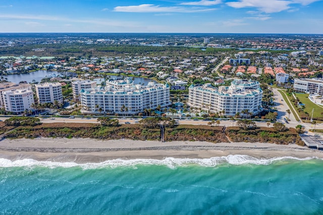 birds eye view of property featuring a water view and a beach view