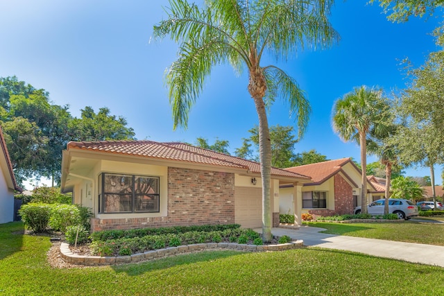 mediterranean / spanish house with a garage and a front lawn