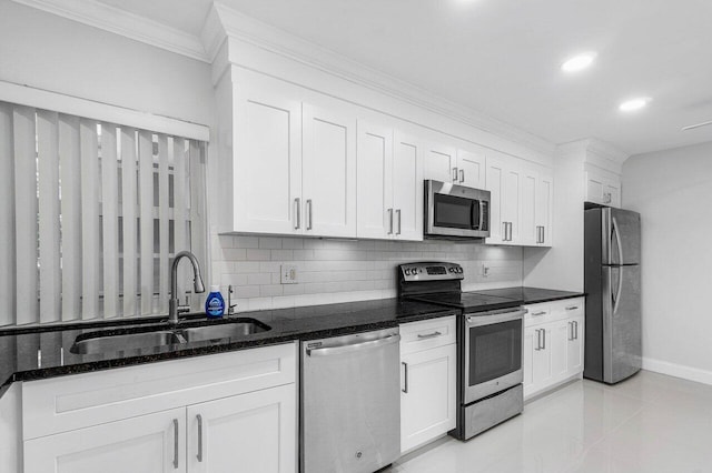 1701 Vision Dr, Palm Beach Gardens, FL 33418 - kitchen featuring stainless steel appliances, a sink, ornamental molding, decorative backsplash, and baseboards