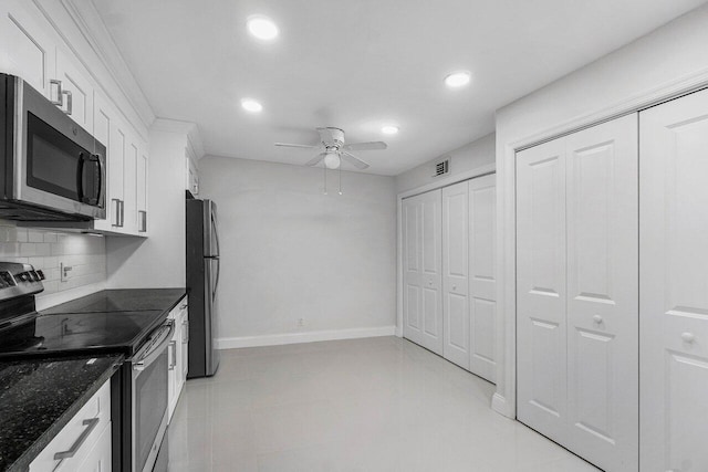 1701 Vision Dr, Palm Beach Gardens, FL 33418 - kitchen with stainless steel appliances, recessed lighting, decorative backsplash, white cabinets, and a ceiling fan