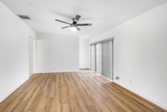 1701 Vision Dr, Palm Beach Gardens, FL 33418 - spare room with light wood finished floors, a textured ceiling, ceiling fan, and baseboards