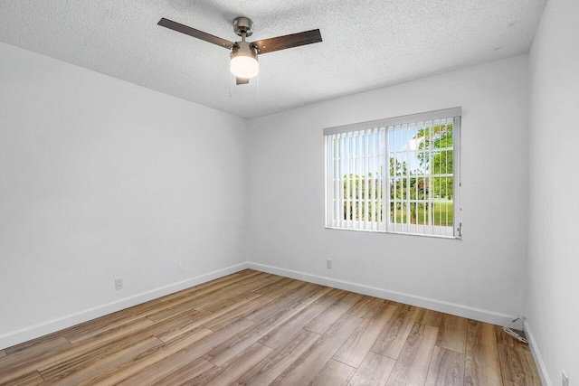 1701 Vision Dr, Palm Beach Gardens, FL 33418 - empty room with light wood finished floors, a ceiling fan, baseboards, and a textured ceiling
