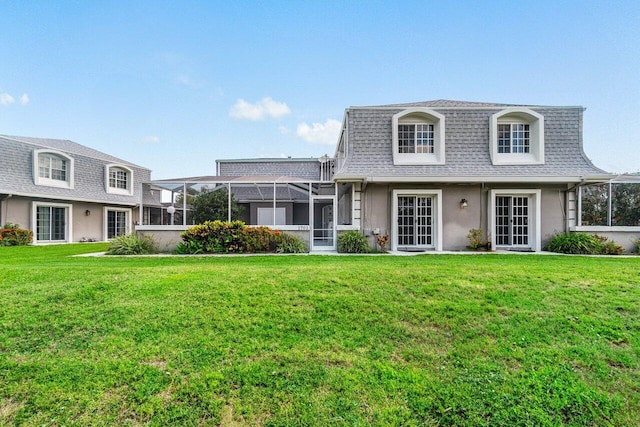 1701 Vision Dr, Palm Beach Gardens, FL 33418 - view of front property with mansard roof, roof with shingles, a front lawn, and stucco siding