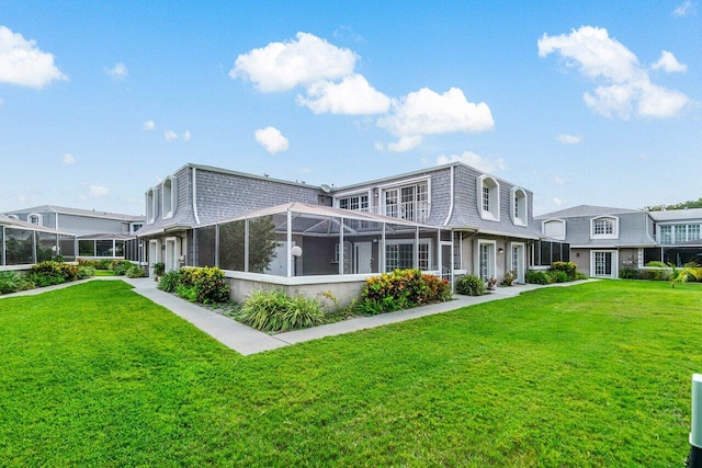1701 Vision Dr, Palm Beach Gardens, FL 33418 - back of property with a yard and mansard roof