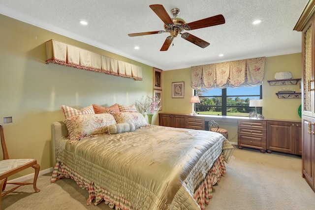 carpeted bedroom with ceiling fan and a textured ceiling