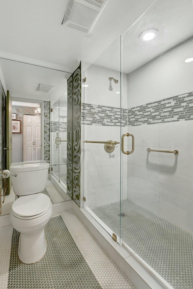 bathroom with toilet, tile patterned floors, and walk in shower