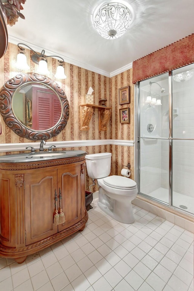 bathroom featuring tile patterned floors, an enclosed shower, vanity, crown molding, and toilet