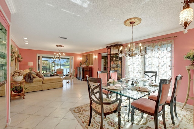 dining space featuring light tile patterned floors, ornamental molding, and a chandelier