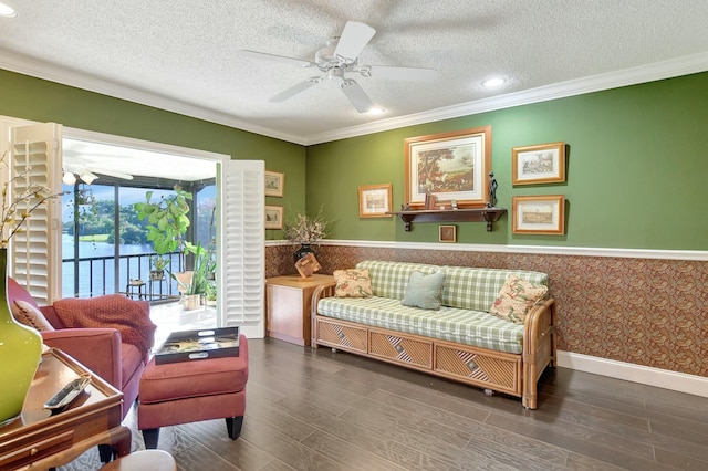 sitting room with dark hardwood / wood-style flooring, ornamental molding, and a textured ceiling