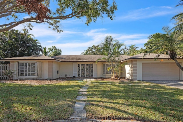 single story home featuring a garage and a front lawn