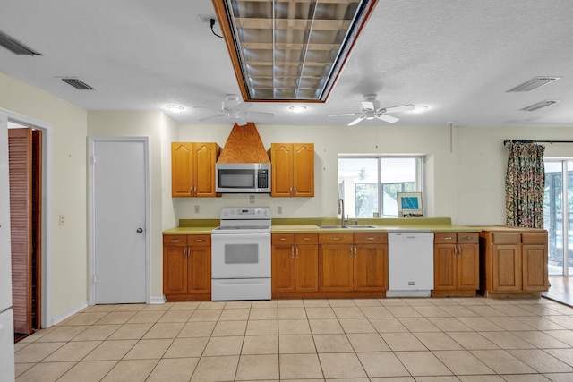 kitchen with light tile patterned flooring, white appliances, plenty of natural light, and sink