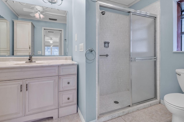 bathroom with tile patterned floors, crown molding, and toilet