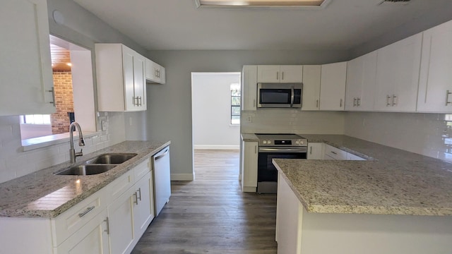 kitchen featuring white cabinetry, sink, light stone countertops, and appliances with stainless steel finishes