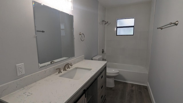 full bathroom featuring tiled shower / bath, hardwood / wood-style floors, vanity, and toilet