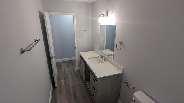 bathroom featuring hardwood / wood-style flooring, vanity, and toilet