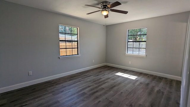 empty room with dark hardwood / wood-style flooring and ceiling fan