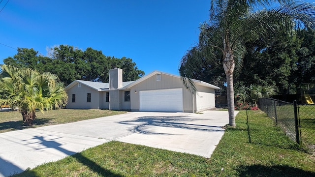 ranch-style house with a garage and a front lawn