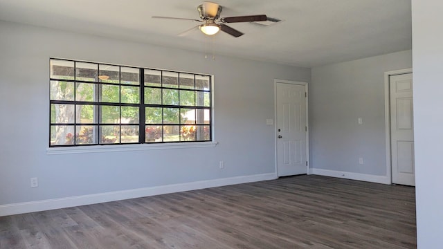 unfurnished room featuring ceiling fan and dark wood-type flooring