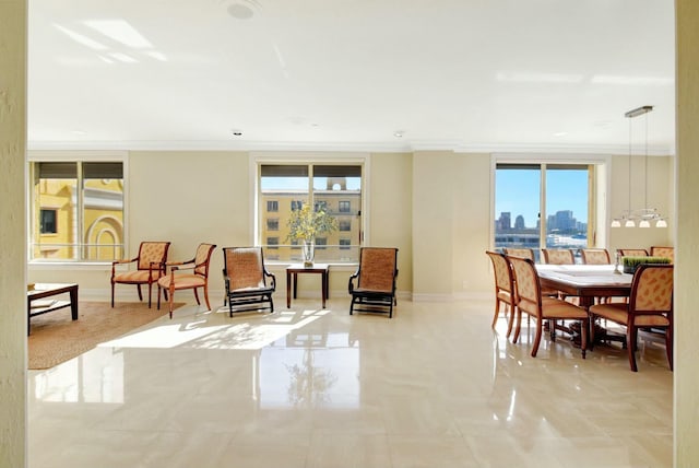 tiled dining room featuring plenty of natural light and ornamental molding