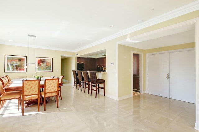 dining space featuring crown molding