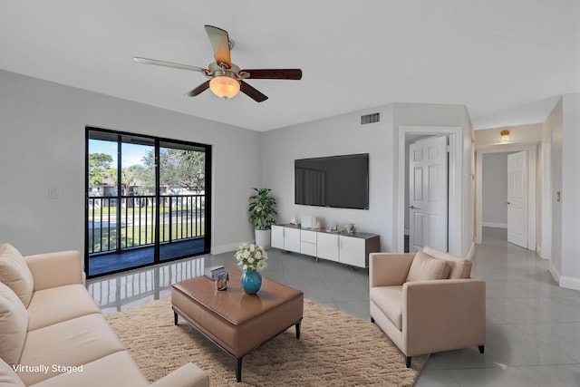 living room featuring tile patterned floors and ceiling fan