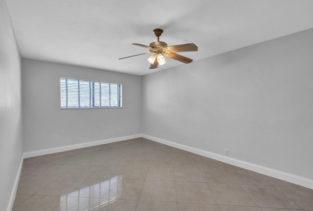 tiled spare room featuring ceiling fan