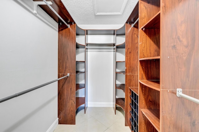 spacious closet with light tile patterned floors