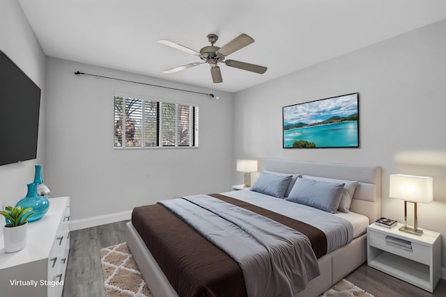 bedroom featuring ceiling fan and dark wood-type flooring