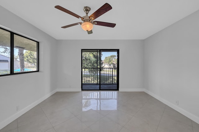 empty room featuring light tile patterned floors and ceiling fan