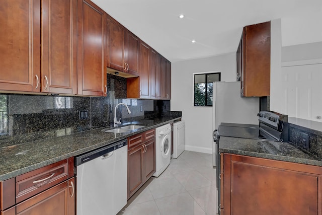 kitchen featuring dark stone counters, sink, dishwasher, washer / dryer, and black / electric stove