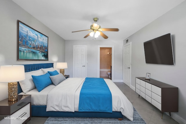 bedroom with ceiling fan, tile patterned flooring, and ensuite bathroom