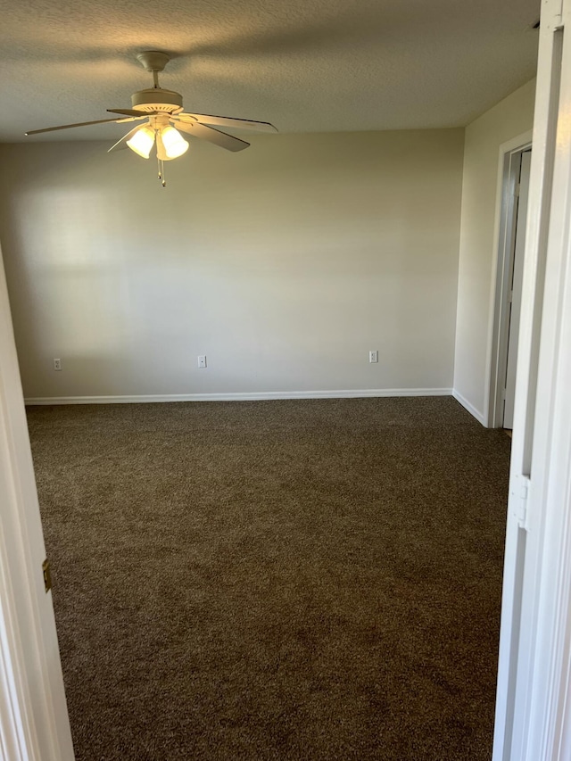 unfurnished room featuring ceiling fan, a textured ceiling, and dark colored carpet