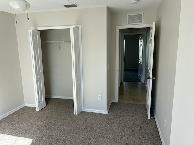 unfurnished bedroom with carpet floors and a closet