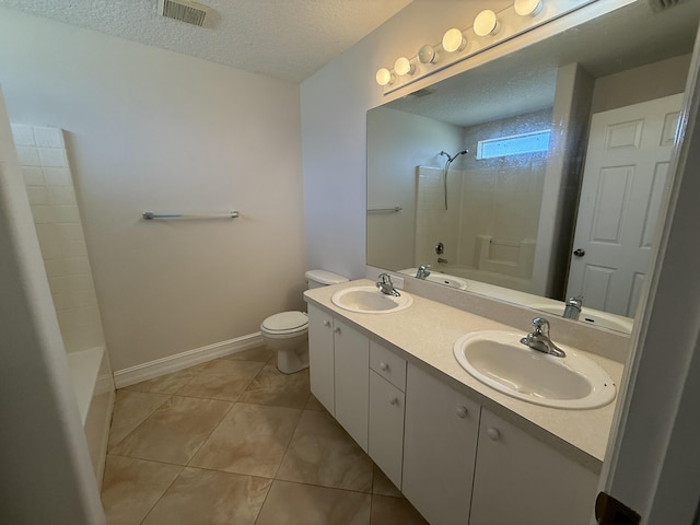 full bathroom with tile patterned flooring, shower / washtub combination, toilet, and a textured ceiling