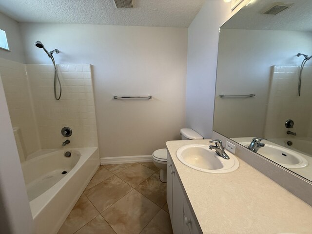 bathroom featuring a textured ceiling, toilet, and bathtub / shower combination