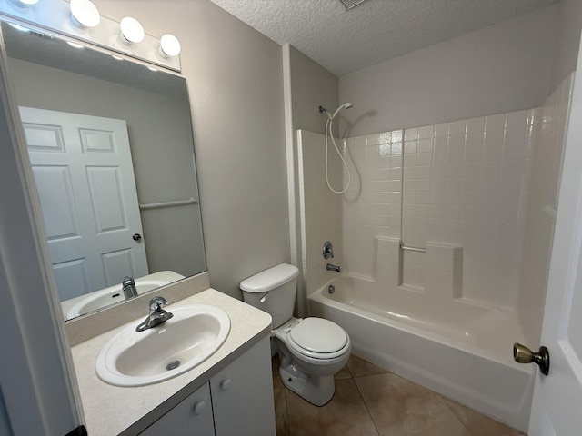 full bathroom with vanity, toilet, bathing tub / shower combination, tile patterned floors, and a textured ceiling