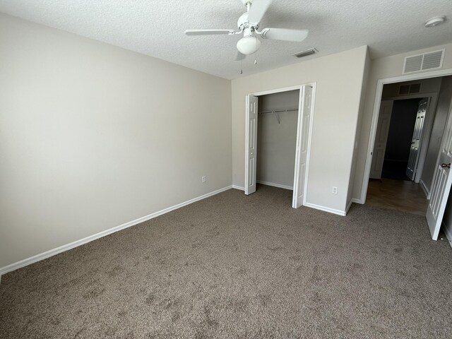 unfurnished bedroom with ceiling fan, carpet flooring, a closet, and a textured ceiling