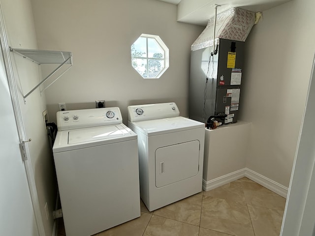 washroom with heating unit, washer and clothes dryer, and light tile patterned flooring