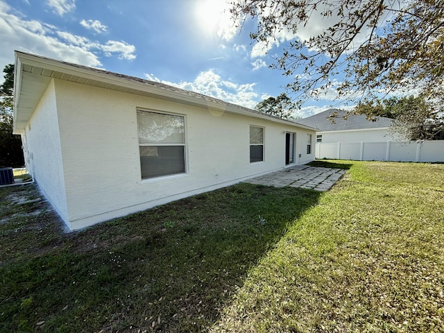 back of property with a lawn