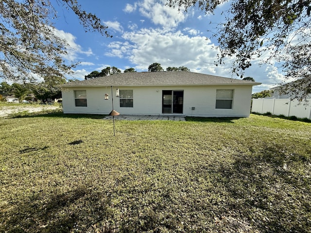 rear view of property with a lawn