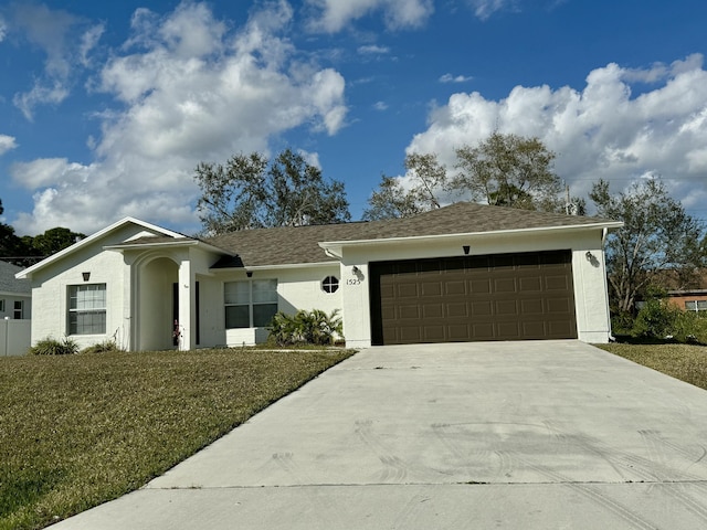 ranch-style home with a garage and a front yard